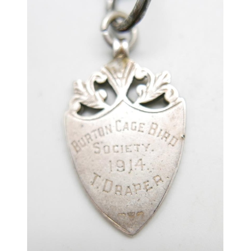 926 - A c1900 sterling silver Albert chain with T-bar and silver fob medal, 'Burton Cage Bird Society, 191... 