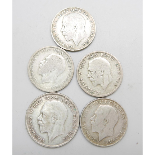 944 - A 1930 half-crown, (rare date), and four silver florins 1921, 1922, 1928 and 1931