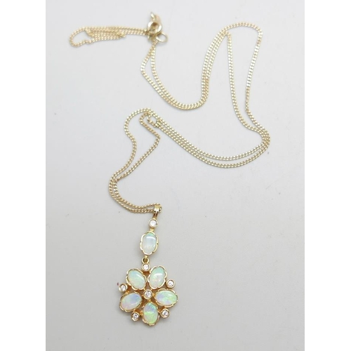 958 - A 9ct gold, opal and diamond pendant on a fine 9ct gold chain, 4.2g, chain 50cm