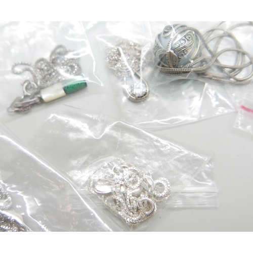 962 - Twenty silver pendants and chains