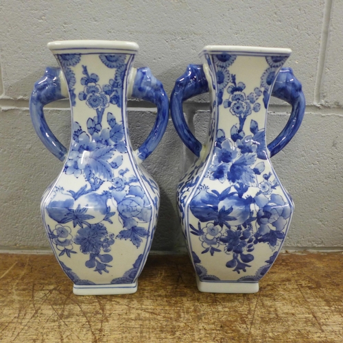 977 - A pair of oriental blue and white two handled vases **PLEASE NOTE THIS LOT IS NOT ELIGIBLE FOR POSTI... 