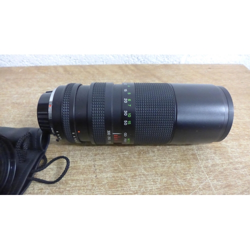 2129 - A Minolta XG-2 35mm film camera, additional 100-30mm lens, 80-200mm lens, Vivitar teleconverter and ... 