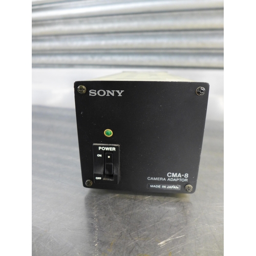 2314 - A Sony (CCU-M3P) 12v/6w camera control unit, a Sony (AC-500CE) AC power adaptor and a Sony (CMA-8CE)... 