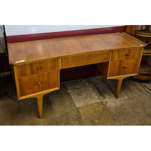 31 - A teak concave desk