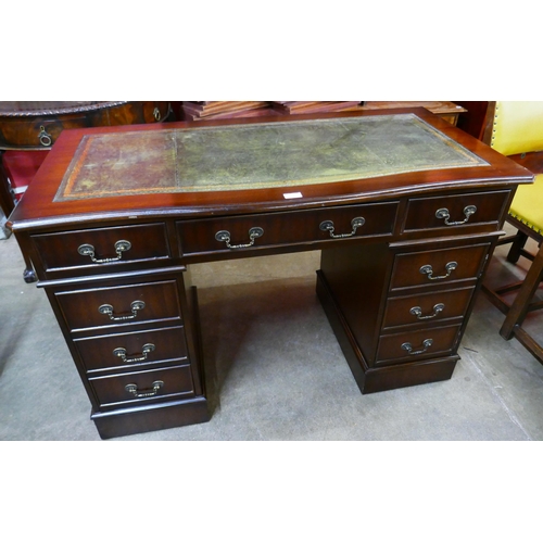 90 - A mahogany and green leather topped pedestal desk