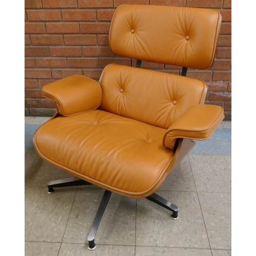 1 - A Charles & Ray Eames style simulated rosewood and tan leather revolving lounge chair and ottoman