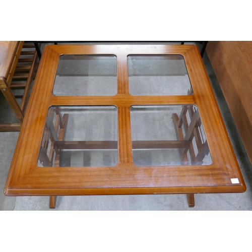 11 - A G-Plan teak and glass topped coffee table