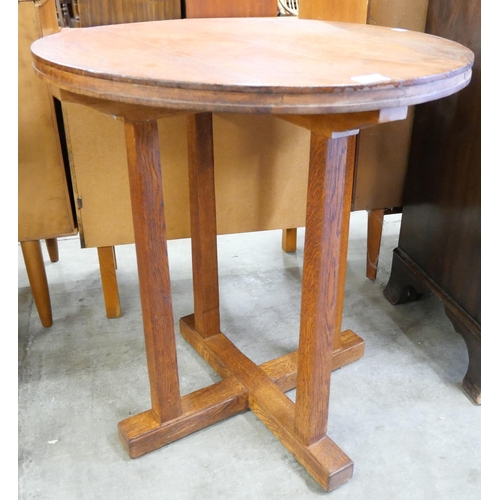 131 - A Cotswold School oak circular table