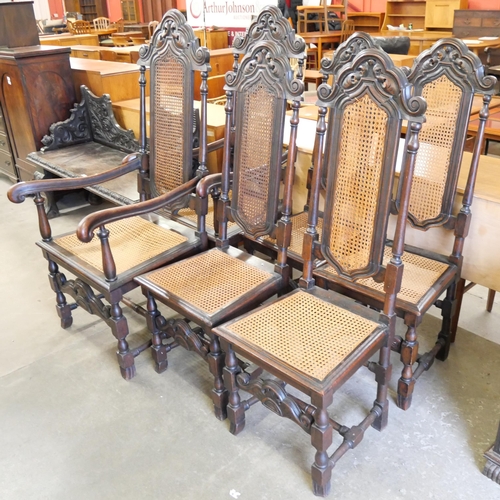 135 - A set of six Carolean style carved oak dining chairs with cane upholstery
