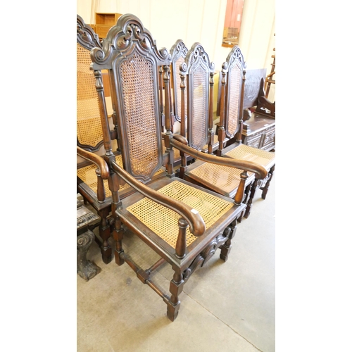 135 - A set of six Carolean style carved oak dining chairs with cane upholstery
