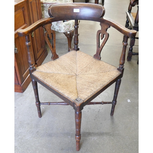 138 - An Arts and Crafts style oak corner chair