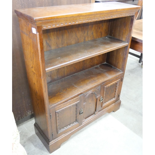 140 - A carved oak open bookcase