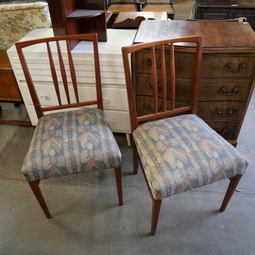 175 - A pair of Gordon Russell mahogany dining chairs, an occasional table, a white painted chest of drawe... 