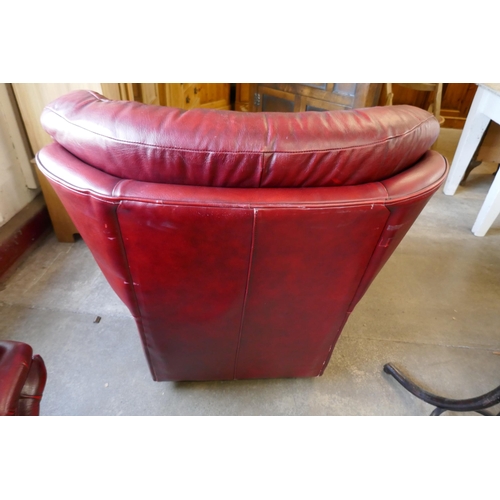 200 - An oxblood red leather armchair