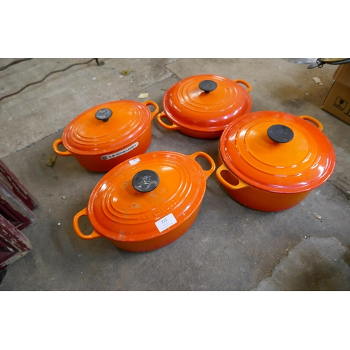 212 - Four Le Creuset volcanic orange cooking pots