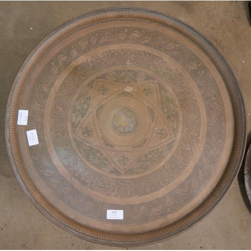 223 - An Islamic copper topped occasional table