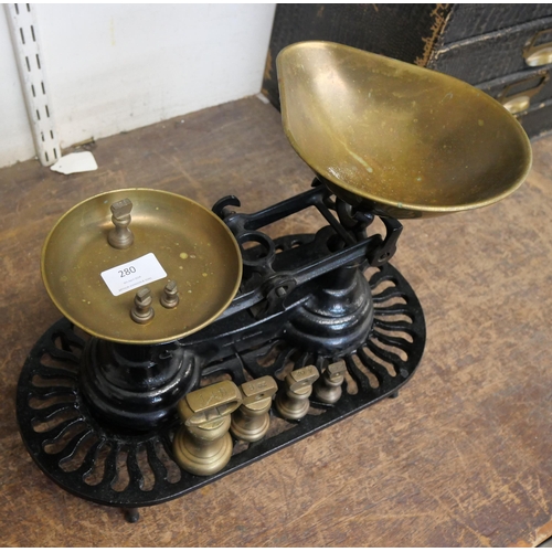 280 - A set of kitchen scales and weights and a cast iron trivet