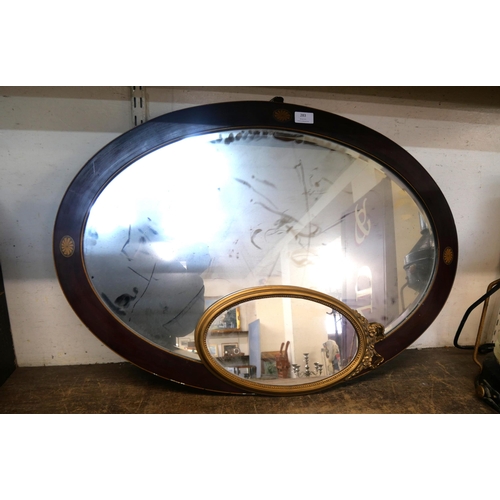 283 - An inlaid mahogany oval mirror and a small gilt framed mirror