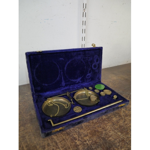 294 - A cased set of brass postal scales and graduated weights