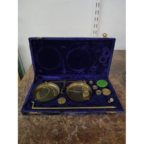 294 - A cased set of brass postal scales and graduated weights