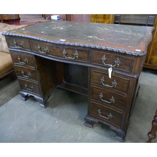 81 - A Chippendale style mahogany and leather topped serpentine desk