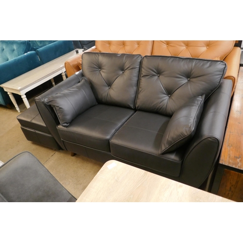 1307 - A black leather Hoxton two seater sofa and footstool RRP £2499