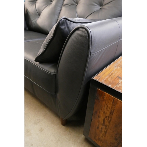 1307 - A black leather Hoxton two seater sofa and footstool RRP £2499