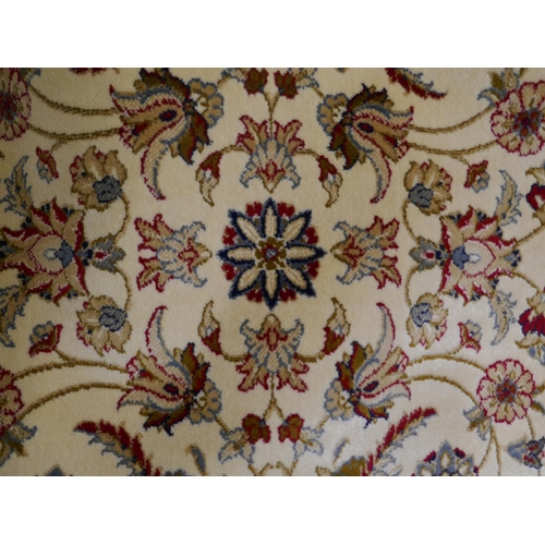 1353 - An ivory ground Cashmere carpet with all over floral pattern and gold border, 300 x 200