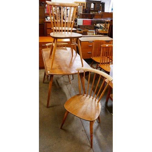 75 - An Ercol elm and beech Windsor drop leaf table and four chairs