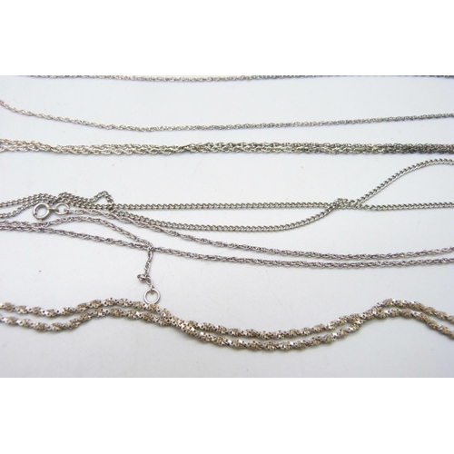 1032 - A collection of silver chains, two pairs of earrings and a single earring