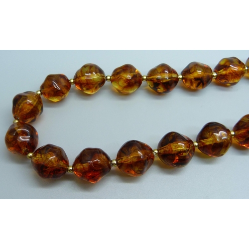 1067A - A Bakelite amber colour bead necklace