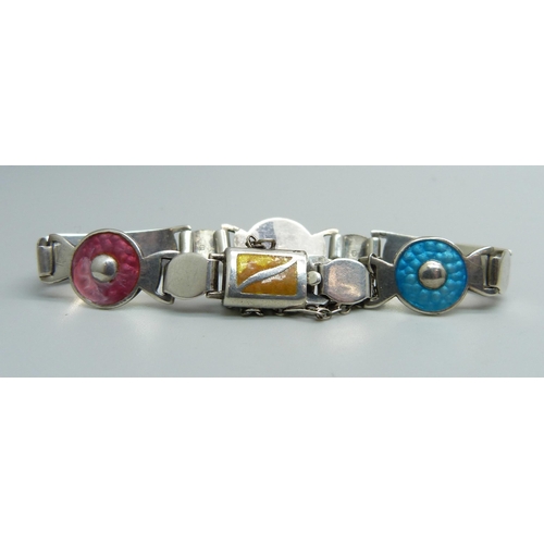 1081 - A silver and enamelled bracelet by James Fenton, one enamel panel a/f