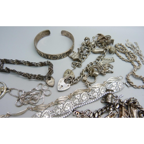 1089 - A collection of silver jewellery including two charm bracelets, 248g