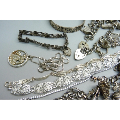 1089 - A collection of silver jewellery including two charm bracelets, 248g