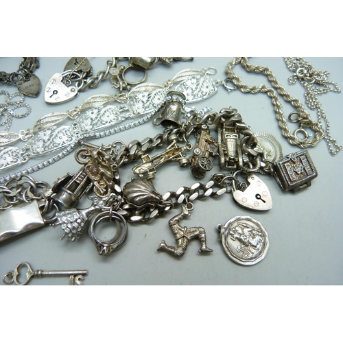 1089 - A collection of silver jewellery including two charm bracelets, 248g