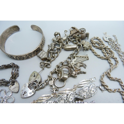 1089 - A collection of silver jewellery including two charm bracelets, 248g