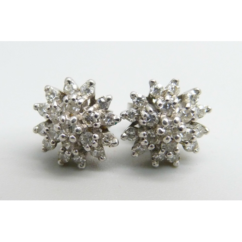 1100 - A pair of 18ct white gold diamond cluster earrings, 4.3g