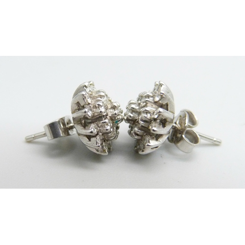 1100 - A pair of 18ct white gold diamond cluster earrings, 4.3g