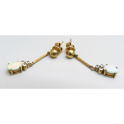 1101 - A pair of opal set pendant earrings, the butterflies marked 18k, 2.6g