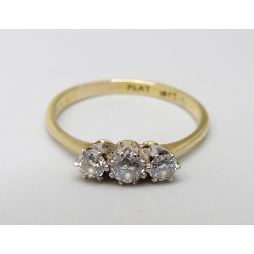 1104A - An 18ct gold and three stone diamond ring, 2.1g, N