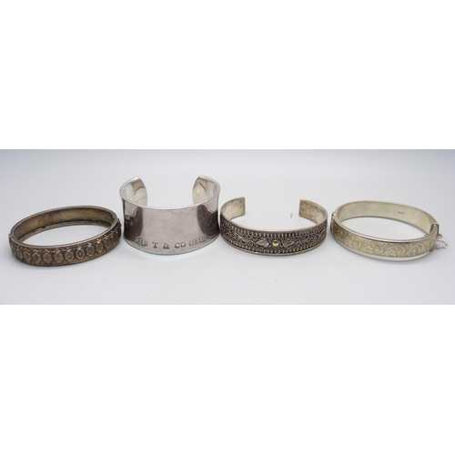 1107 - Four silver bangles including one Tiffany, 135g