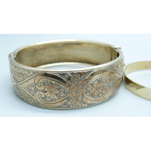 1112 - A silver gilt bangle and a 9ct gold metal core bangle