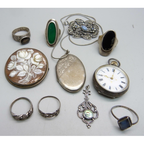 1116 - A silver locket and chain, six silver rings, etc., and a 935 silver fob watch