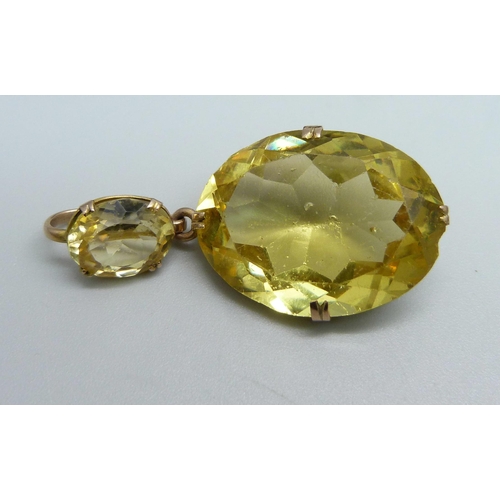 1128 - A yellow metal mounted citrine drop pendant, tests as 9ct gold, a yellow metal horseshoe stick pin a... 