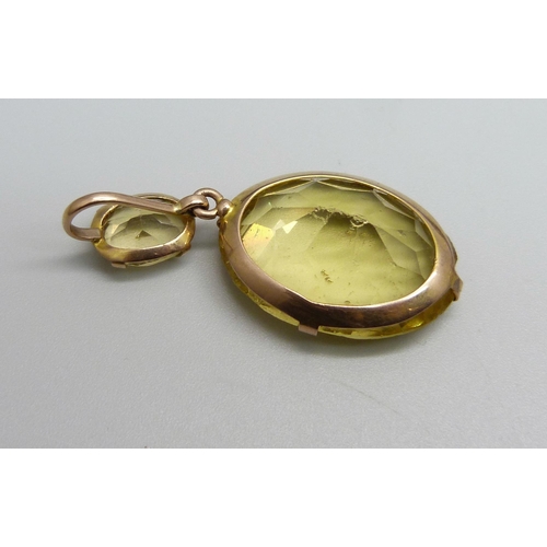 1128 - A yellow metal mounted citrine drop pendant, tests as 9ct gold, a yellow metal horseshoe stick pin a... 