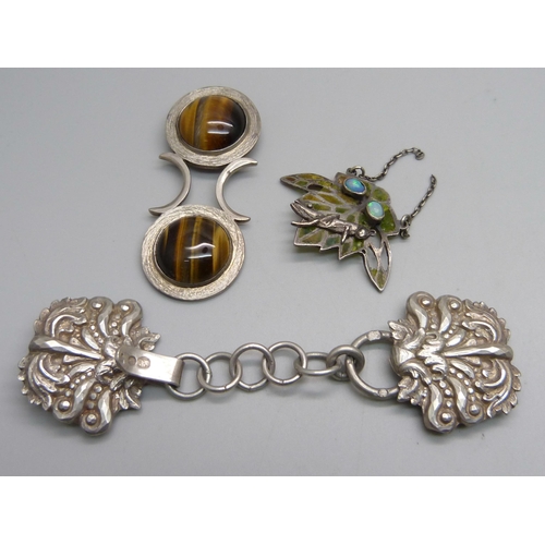 1131 - A silver and tiger's eye pendant, a white metal buckle with continental control mark and a pendant/p... 