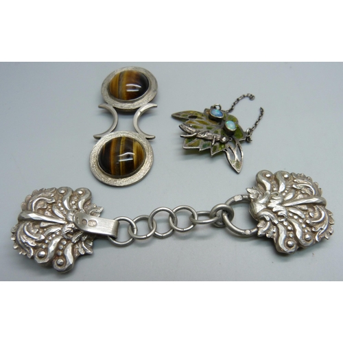 1131 - A silver and tiger's eye pendant, a white metal buckle with continental control mark and a pendant/p... 