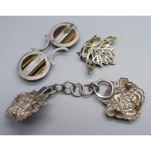 1131 - A silver and tiger's eye pendant, a white metal buckle with continental control mark and a pendant/p... 