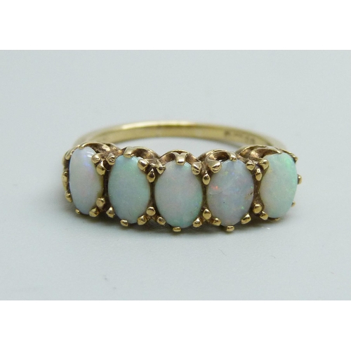 1145 - A 9ct gold and five stone opal ring, 2.7g, O