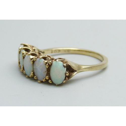 1145 - A 9ct gold and five stone opal ring, 2.7g, O